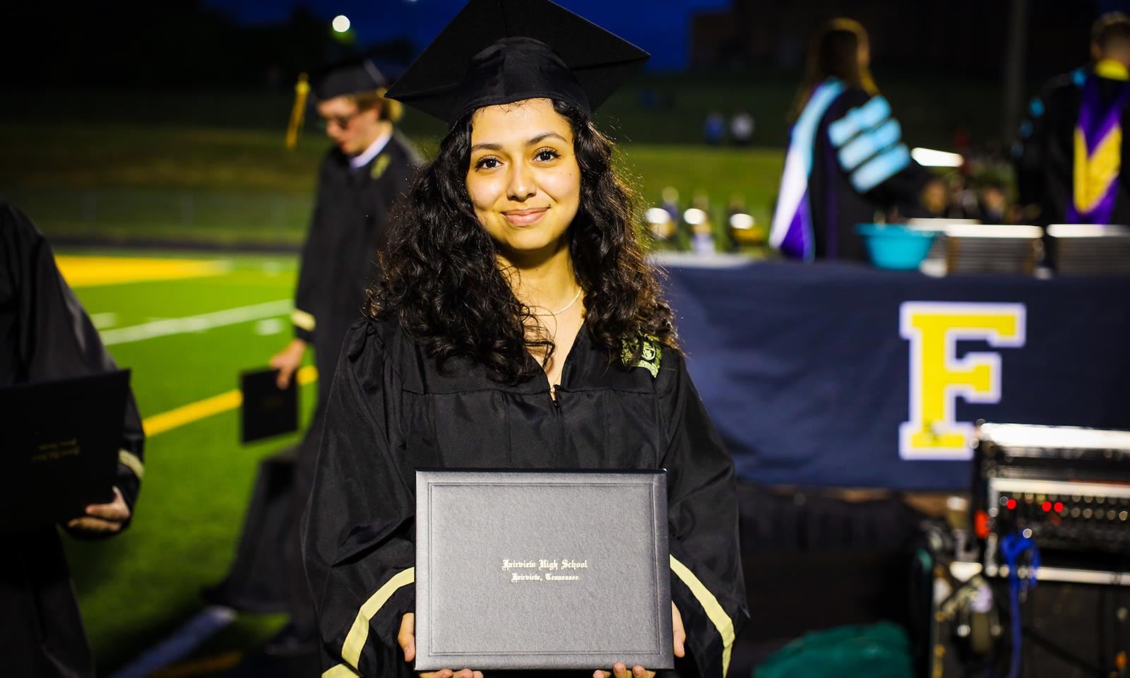 A girl holds a diploma